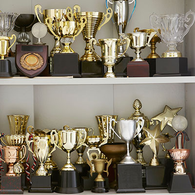 Trophies on a local trophy shops showroom shelf.